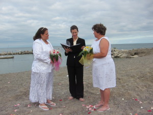 Two New Yorkers getting married at Kew Beach in Toronto's east end just as New York state legalizes same sex marriage.